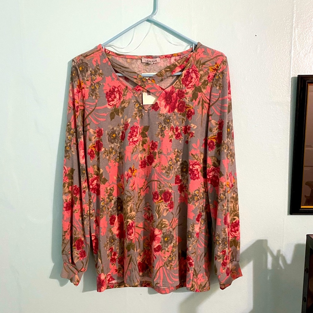 Floral-print, loose-fitting top with cross-cross neckline!